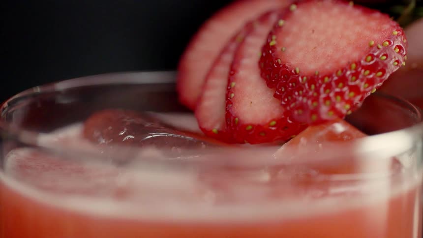 Strawberry pieces are put into a beverage