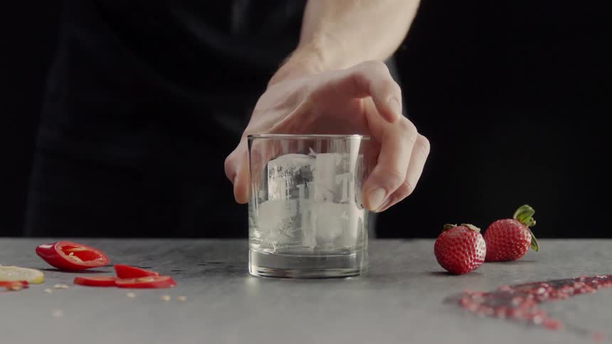 A person puts a class down full of ice