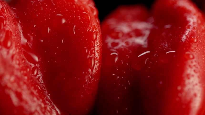The red peppers have water spilling all over them