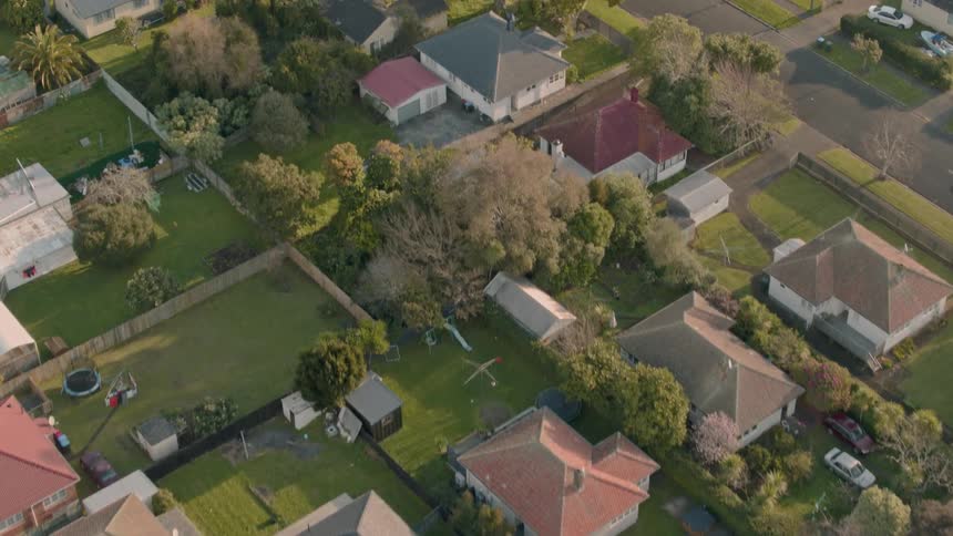 Residential houses and vehicles cover the landscape