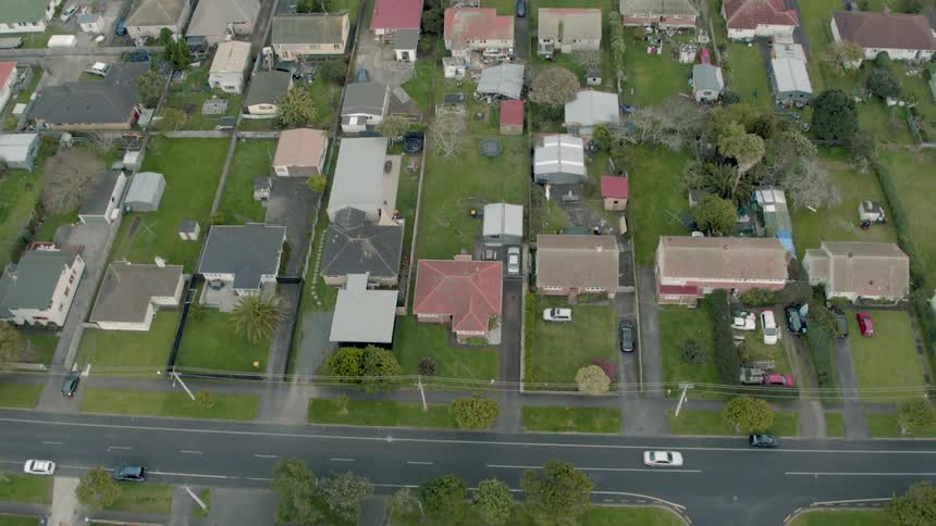 Residential houses and vehicles cover the landscape