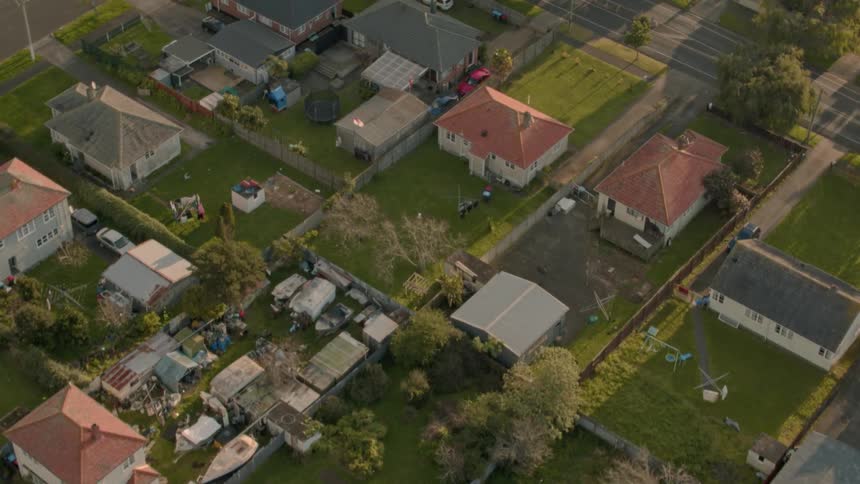 Residential houses and vehicles cover the landscape