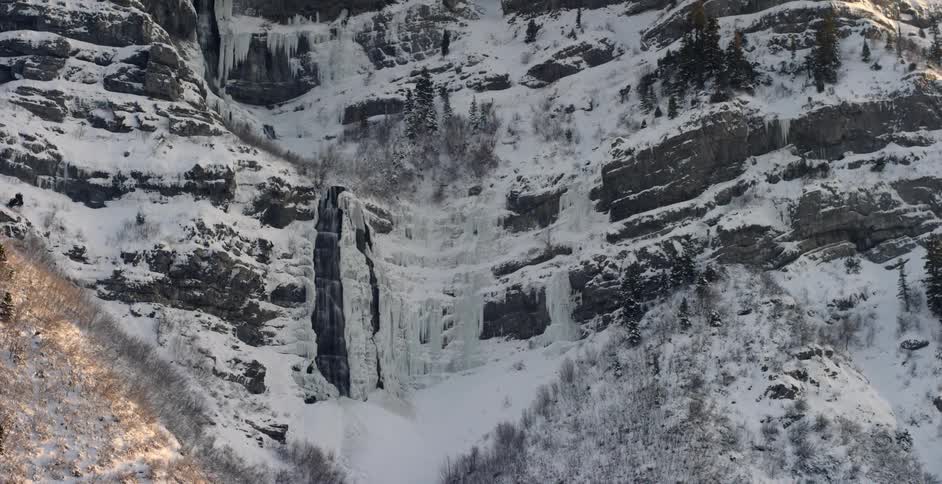 Snow and ice cover a mountain cliff
