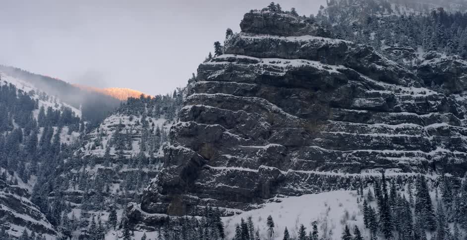 Snow lines the ridges of a mountain