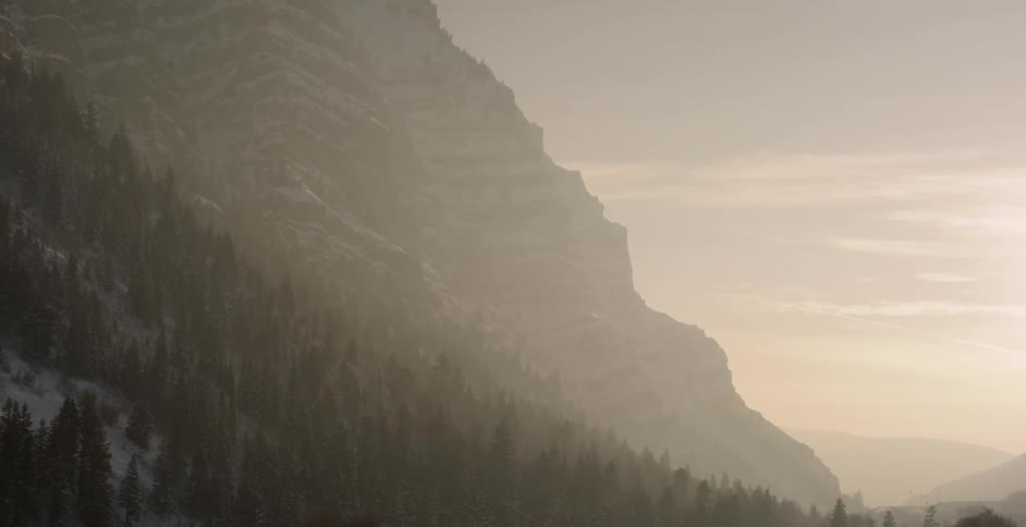 The tall mountain is covered with fog