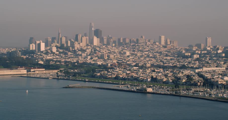 The large city ahead has a cloudy sky above