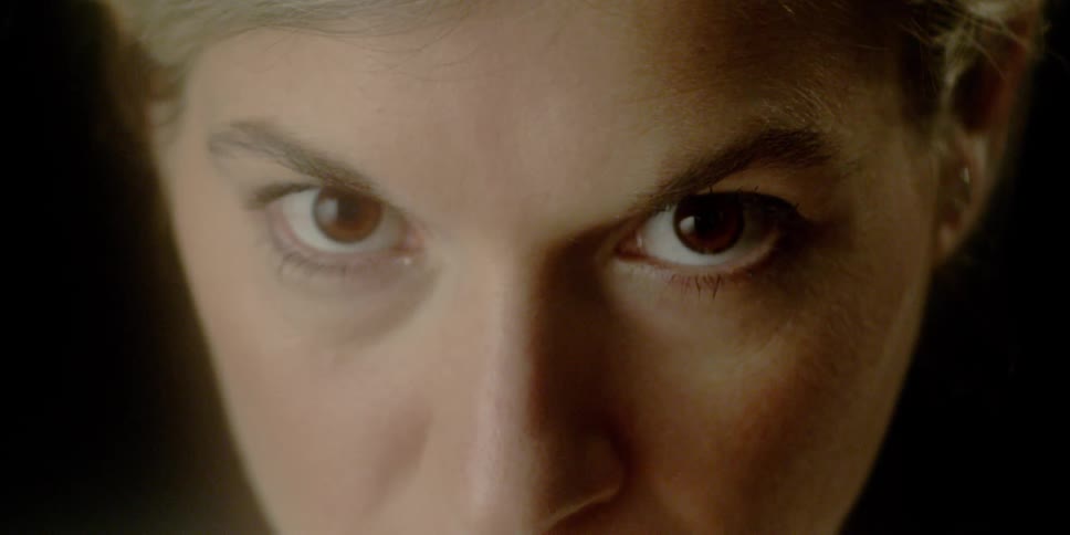 A woman raises her gaze and looks forward