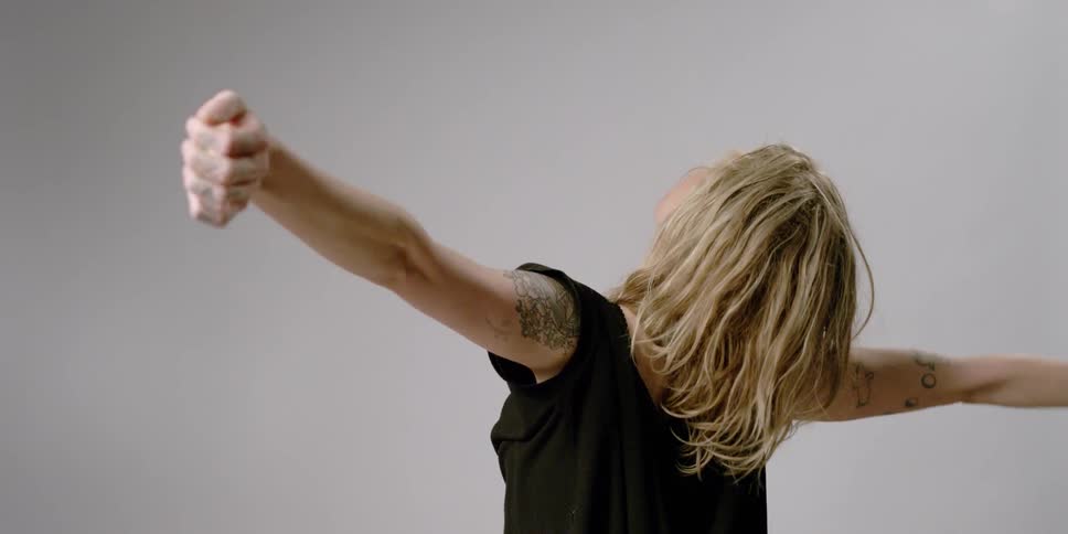 Woman stretches her arms and neck