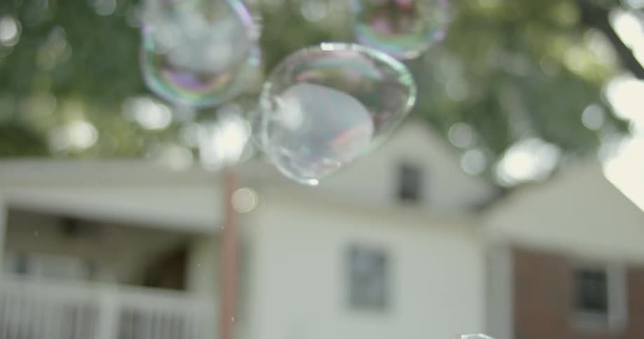 Bubbles float in the air near a house