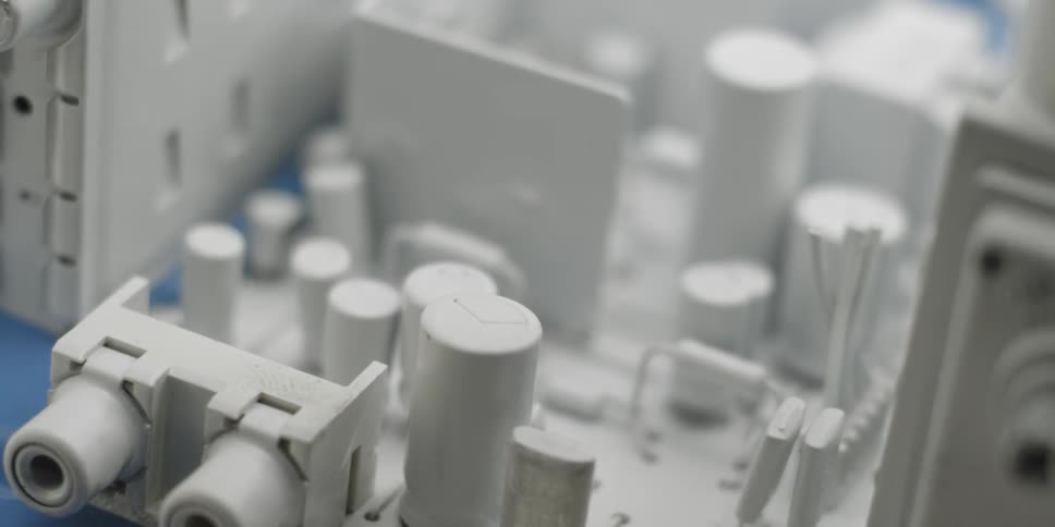 A white circuit board is filmed up close