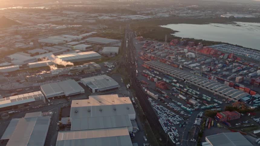 A large industrial park is being filmed from a drone