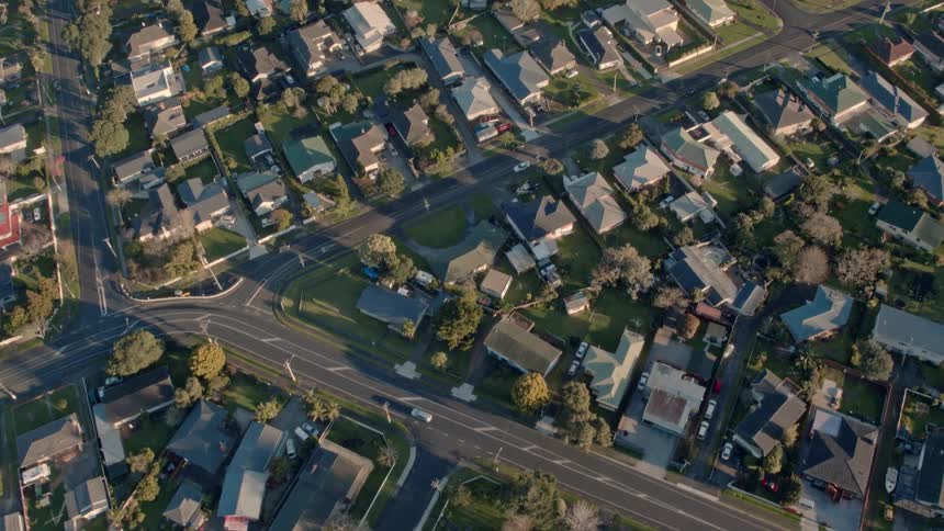 A small neighborhood is being filmed from a drone