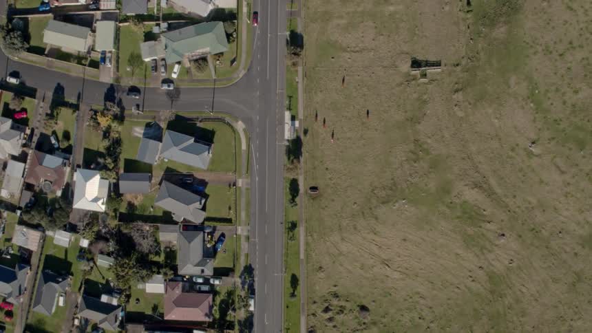 A neighborhood across from an empty field