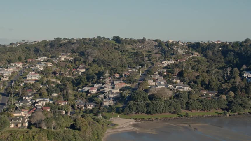 A community exists on hills overlooking a coastline