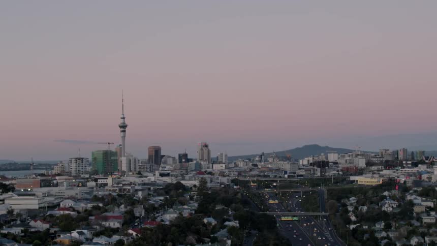 The cars drive down the main road through this city