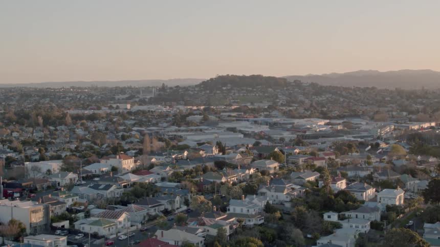 Sun sets over houses in a neighborhood