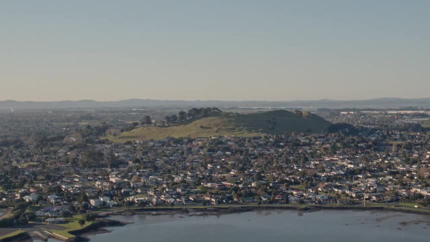 The shore below is surrounded by many buildings and homes
