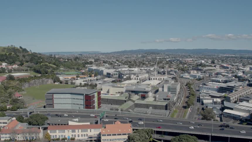 View of a city and cars driving down a highway