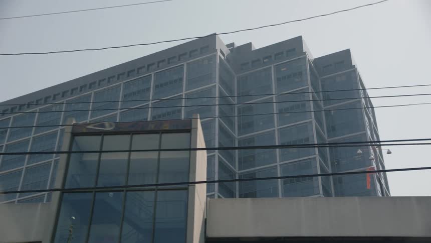 Power lines in front of a building on a sunny day