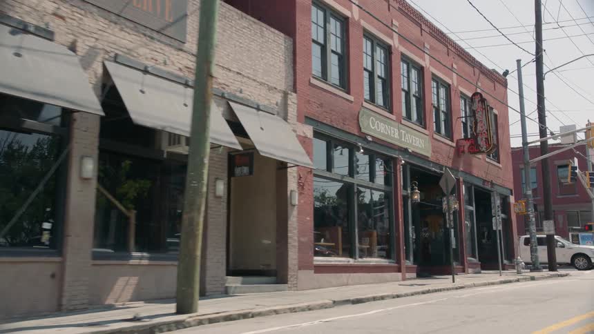 Old buildings and a tavern line the streets of a small town