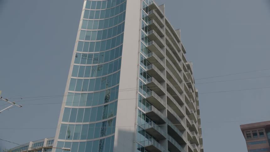 A tall glass building in a city