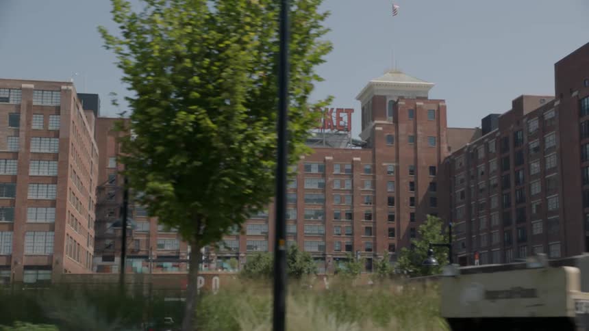 People work and drive on the road in front of this building complex