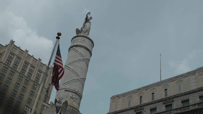 A statue stands in a city