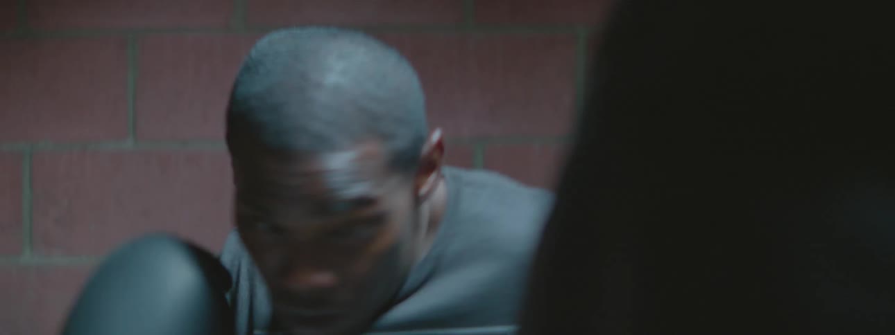A man is boxing a heavy punching bag
