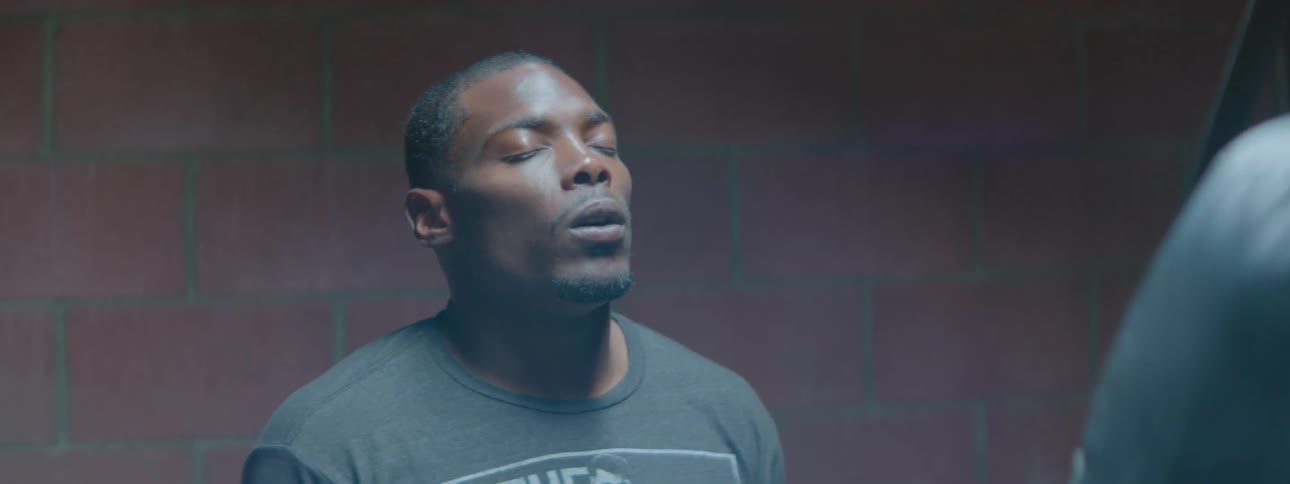 A man with closed eyes breathes deeply