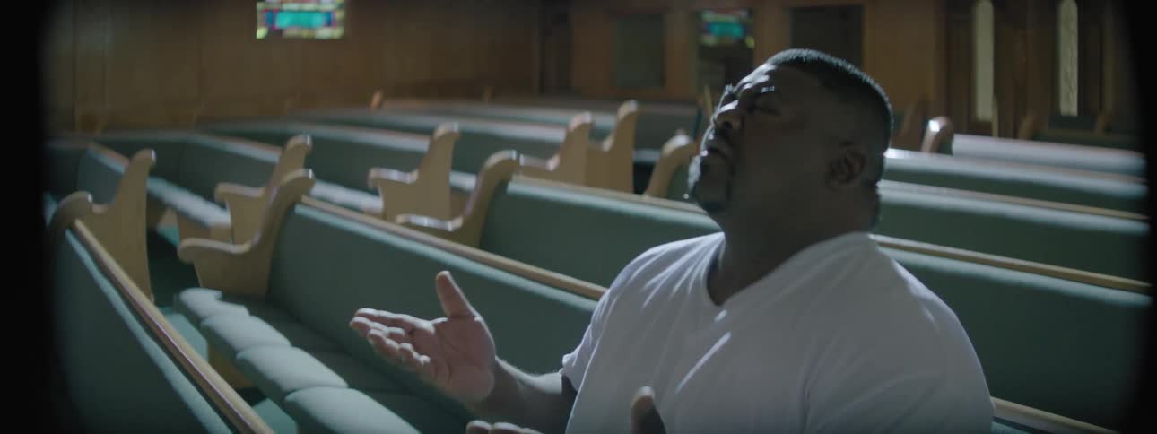 Man sitting in a pew at a church praying