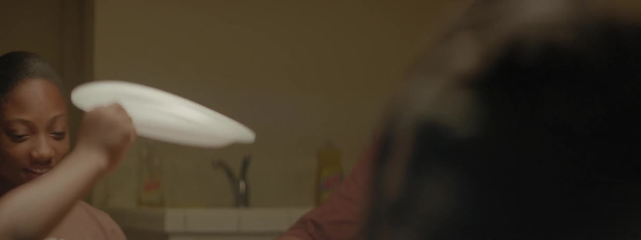 Family prays at the dinner table and passes plates