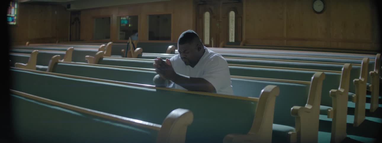 A man is sitting in church and praying