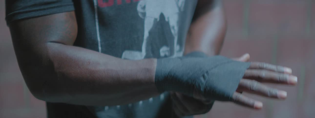 Man wraps hands with athletic tape