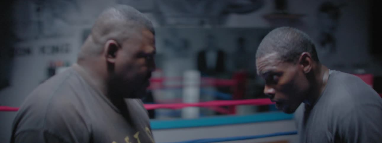 The two boxers spar together practicing in the ring