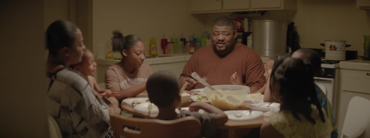 A family talk and eat at the supper table