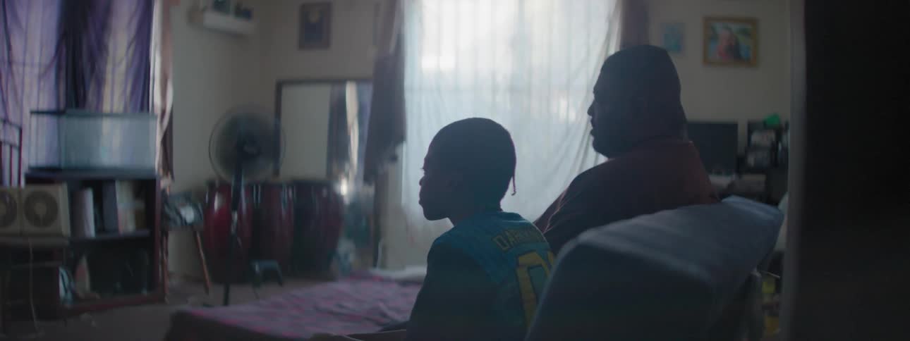 Child and man sit on the couch in a living room