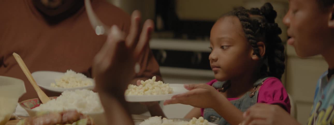Family preparing their plates with food at dinner