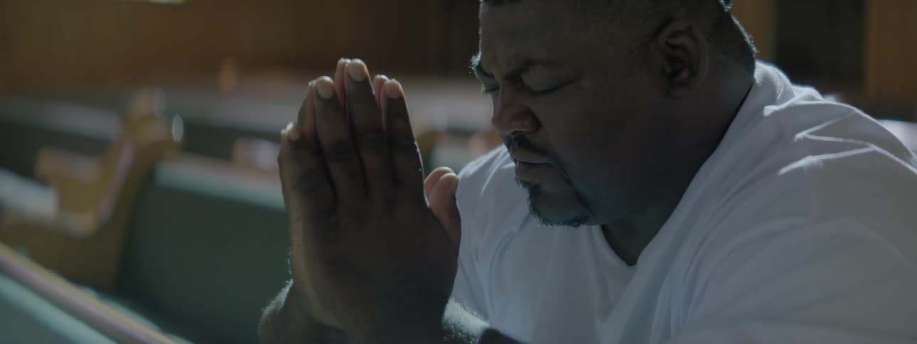 A man prays in a chapel