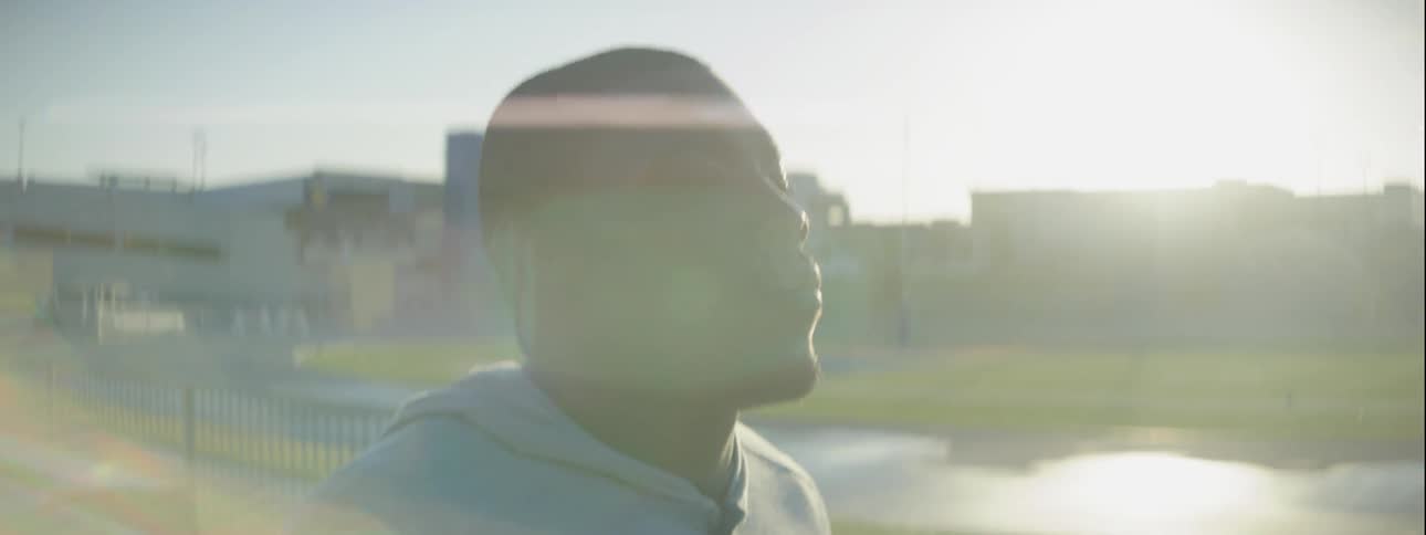 Man walks outside in the city on a sunny day