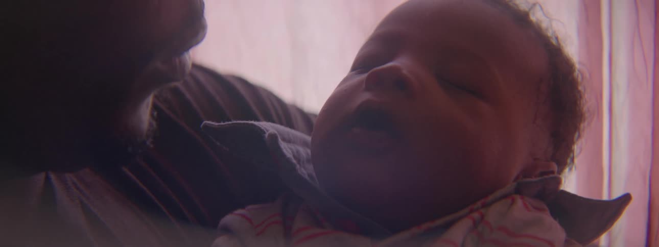 Man holds a sleeping baby