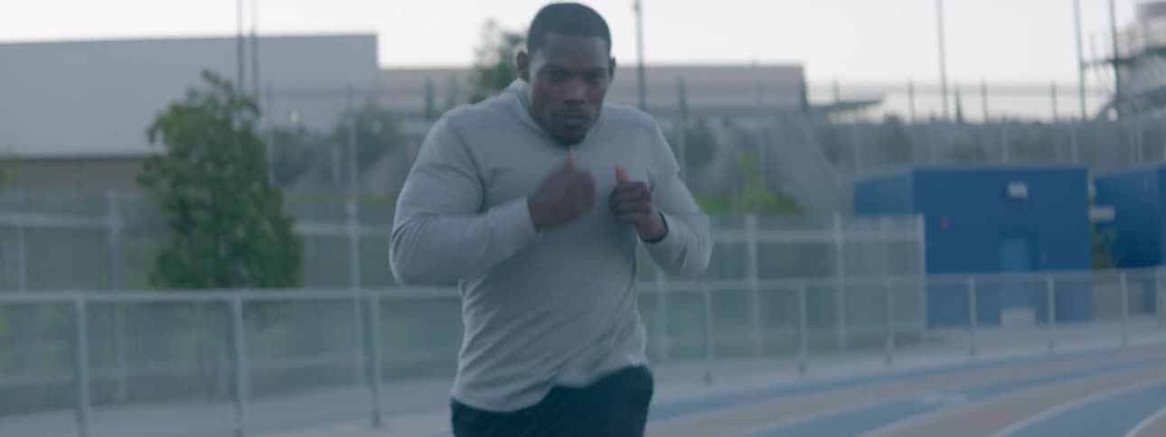 A man in sweats is running track