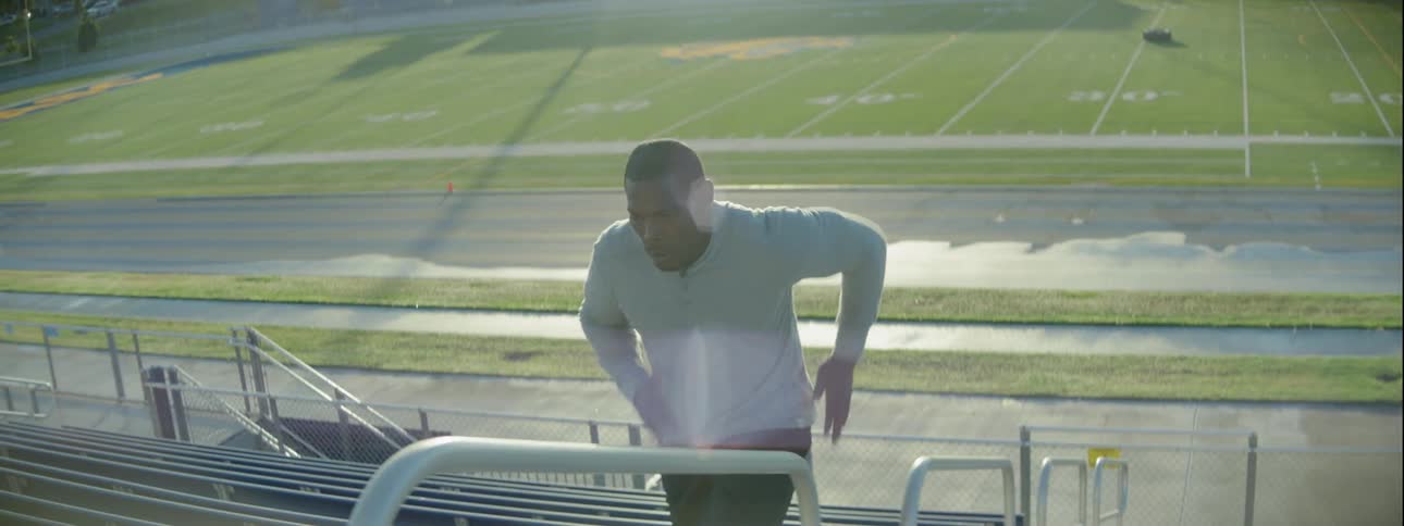A man runs up and back down stadium steps