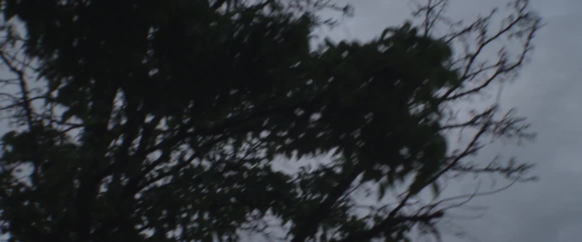 A helicopter is flying across the sky on a cloudy day