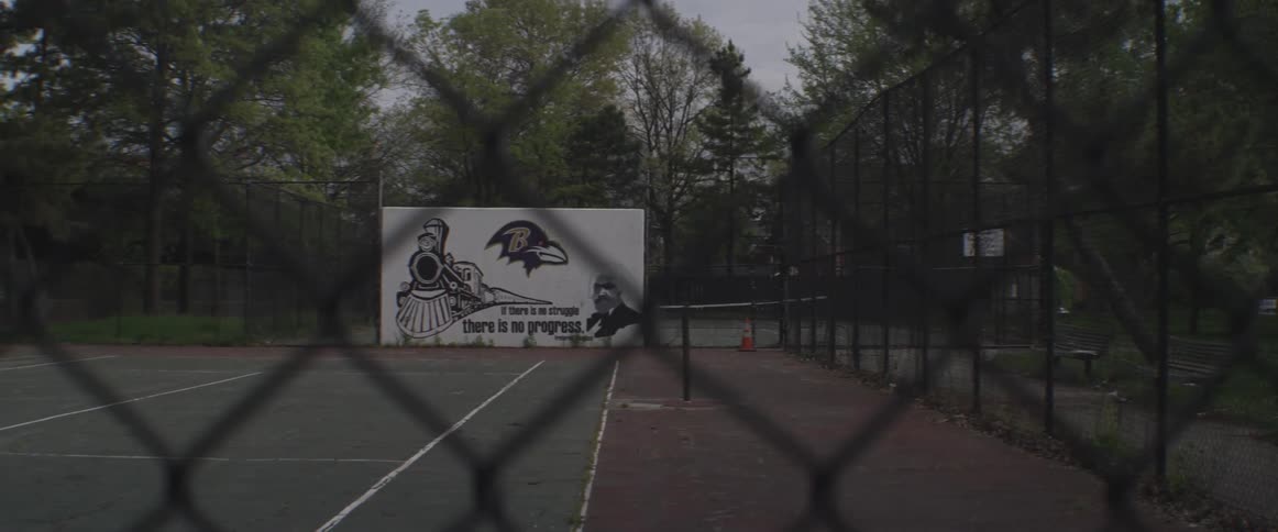 A billboard is placed ahead of the tennis court