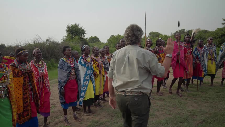 A man visits with maasai people