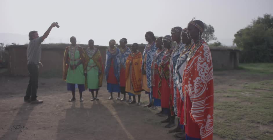 A man photographs maasai people