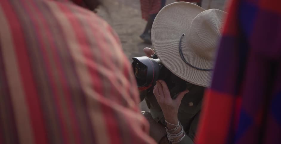 Woman takes pictures of maasai people
