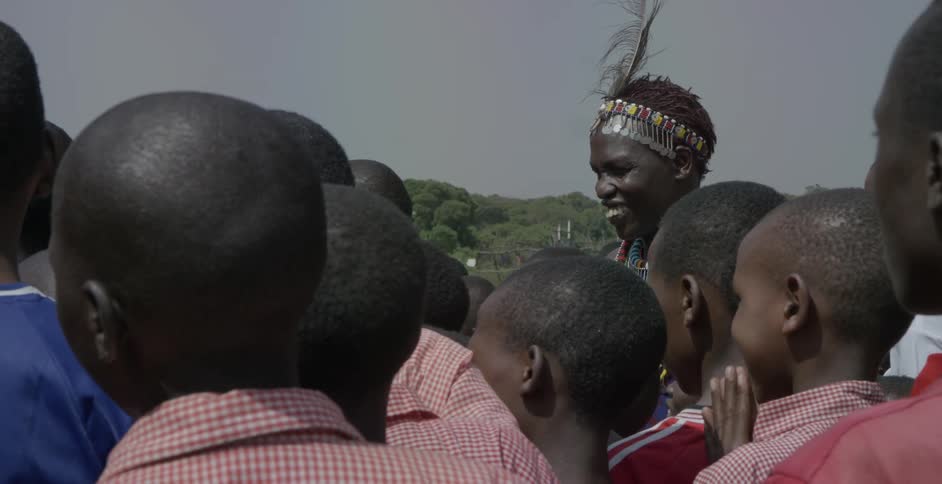 Maasai children stand together on a cloudy day