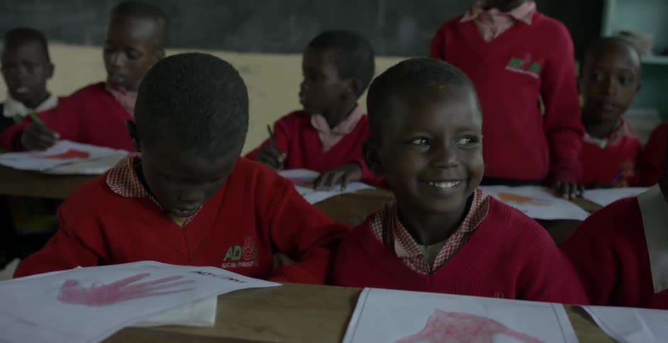 The children laugh and talk in class