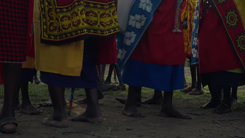 A group of maasai walk around a field